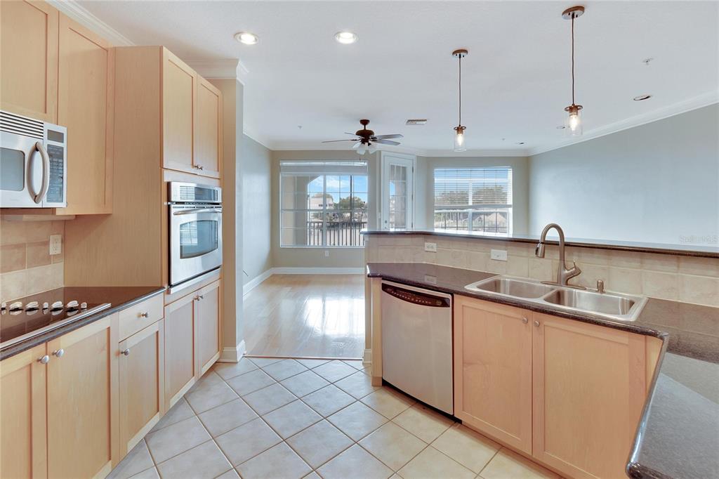 6414 Sunset Bay Circle Apollo Beach, FL 33572 - Photo 13 of 52 a kitchen with stainless steel appliances a sink stove and cabinets