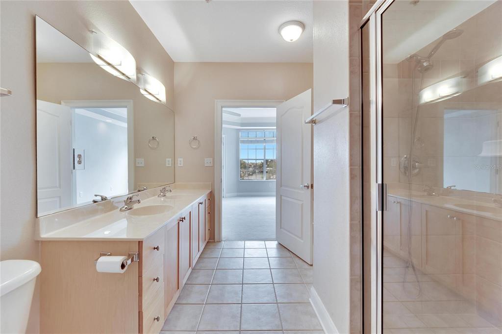 6414 Sunset Bay Circle Apollo Beach, FL 33572 - Photo 26 of 52 a bathroom with a double vanity sink a mirror and a shower