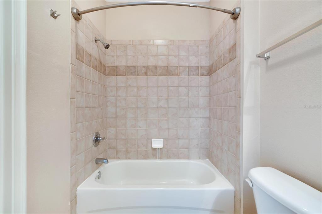 6414 Sunset Bay Circle Apollo Beach, FL 33572 - Photo 34 of 52 a bathroom with a white bath tub and a shower