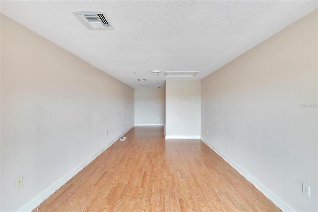 6414 Sunset Bay Circle Apollo Beach, FL 33572 - Photo 36 of 52 a view of an empty room with wooden floor