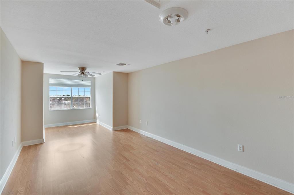 6414 Sunset Bay Circle Apollo Beach, FL 33572 - Photo 40 of 52 a view of a room with wooden floor and a kitchen