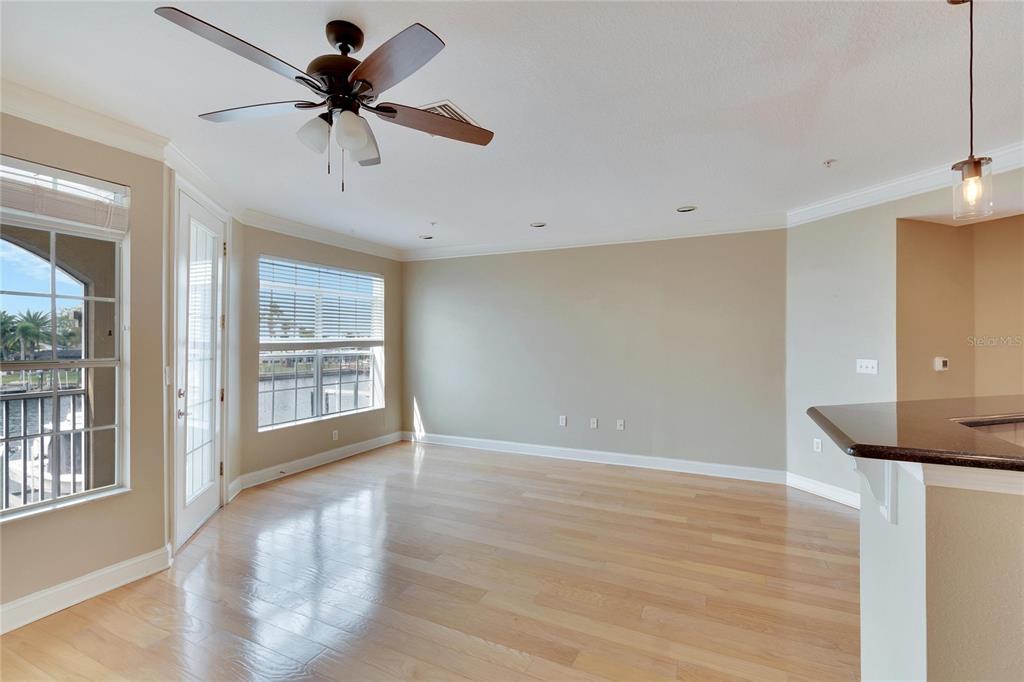 6414 Sunset Bay Circle Apollo Beach, FL 33572 - Photo 7 of 52 a view of an empty room with a window and wooden floor