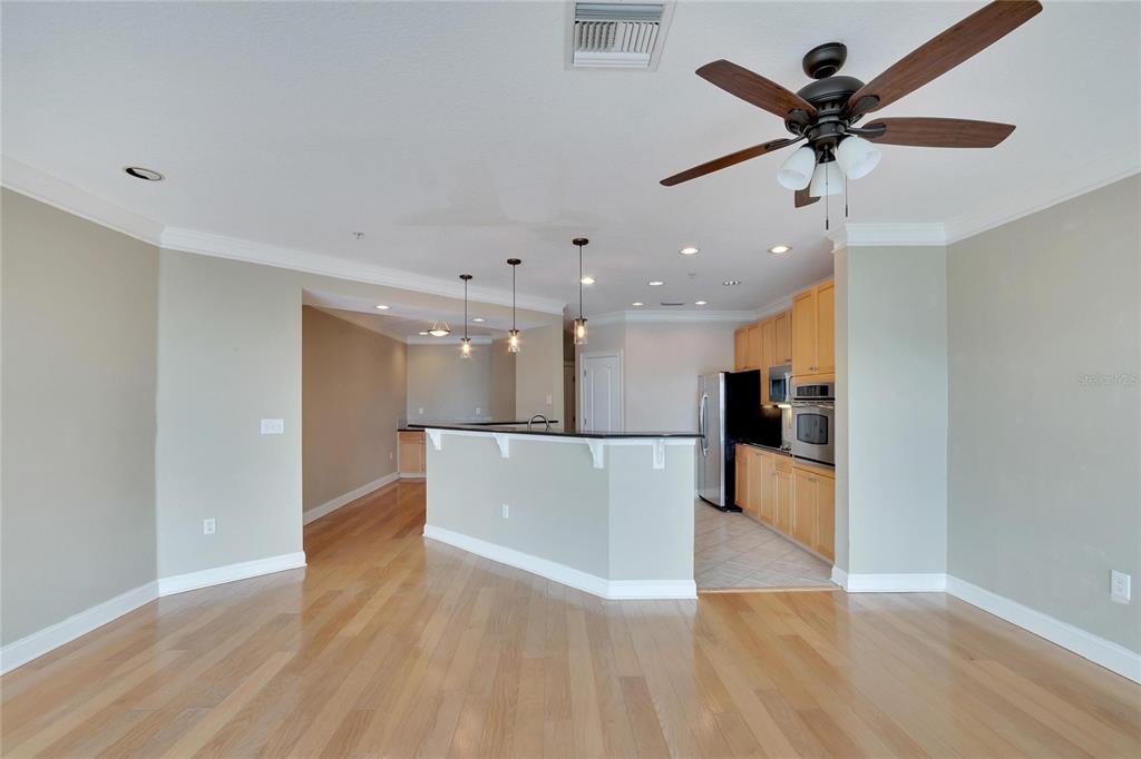 6414 Sunset Bay Circle Apollo Beach, FL 33572 - Photo 8 of 52 a view of a big room with wooden floor and a ceiling fan