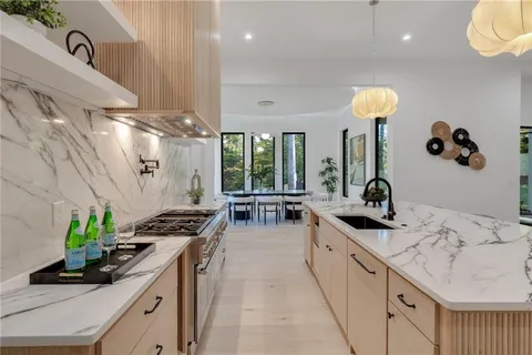 a kitchen with a sink stove and cabinets