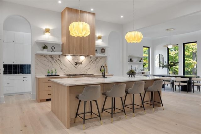 a kitchen with a sink and chairs