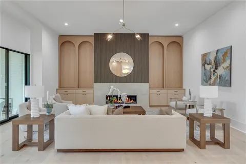 a living room with furniture a clock and a large mirror