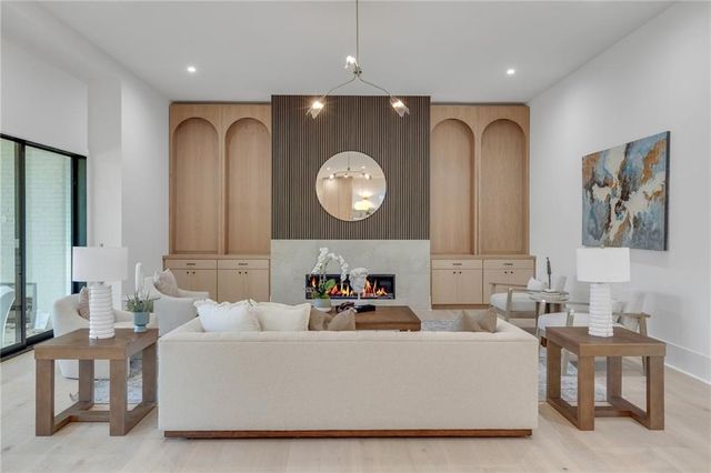 a living room with furniture a clock and a large mirror