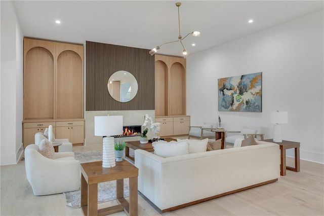 a living room with furniture a large window and a clock