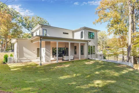 a view of a house with a yard and sitting area