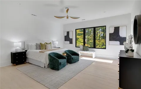 a spacious bedroom with a large bed and a large window