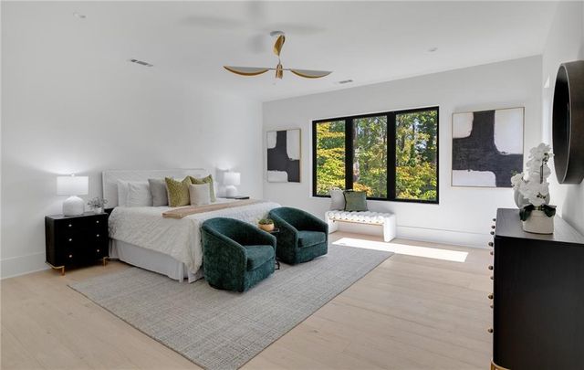 a spacious bedroom with a large bed and a large window