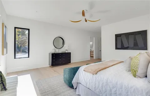 a bedroom with a bed and a dresser