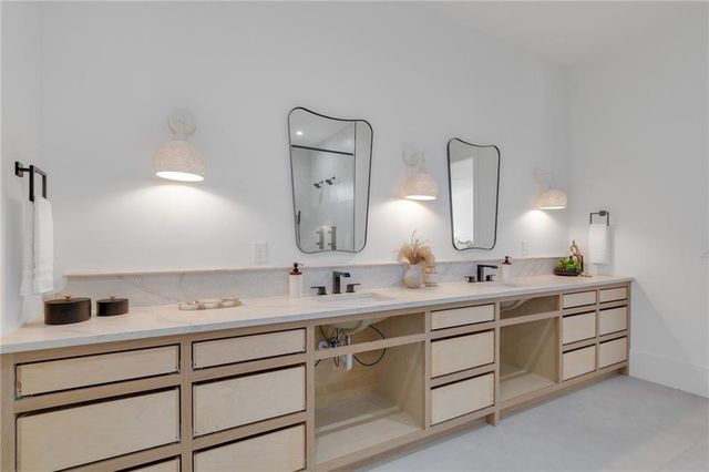 a bathroom with a double vanity sink and mirror