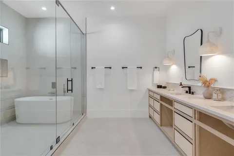 a bathroom with a tub sink and mirror