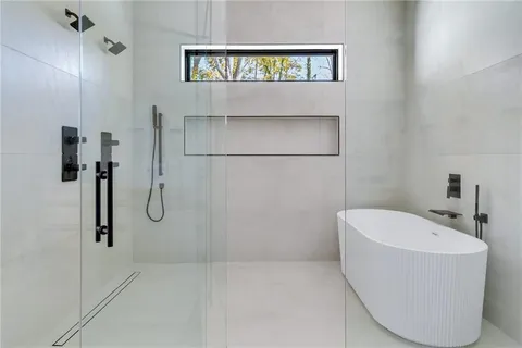 a bathroom with a bathtub and a shower