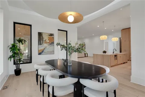 a living room with furniture potted plant and a table