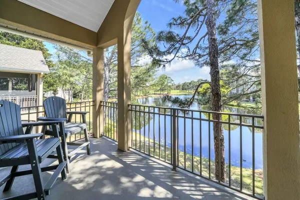 a view of balcony with wooden floor and outdoor seating