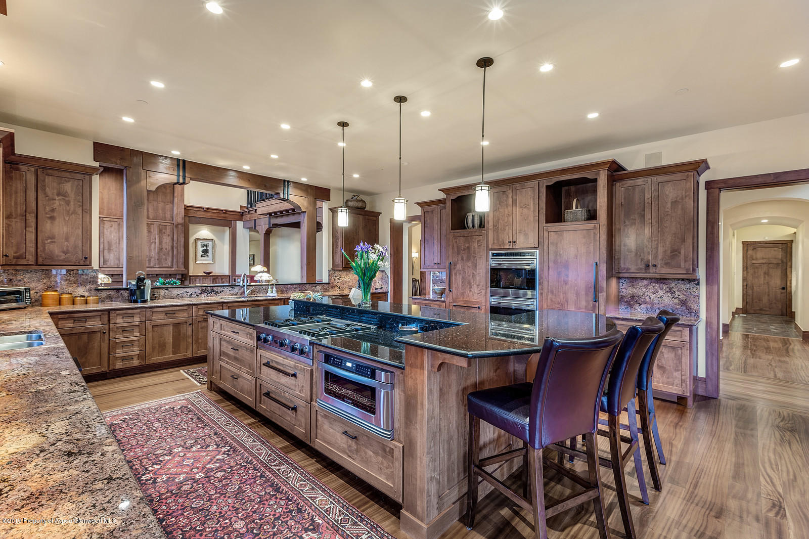 340 River's Bend Carbondale, CO 81623 - Photo 15 of 54 a kitchen with stainless steel appliances granite countertop a stove top oven a sink dishwasher a dining table and chairs