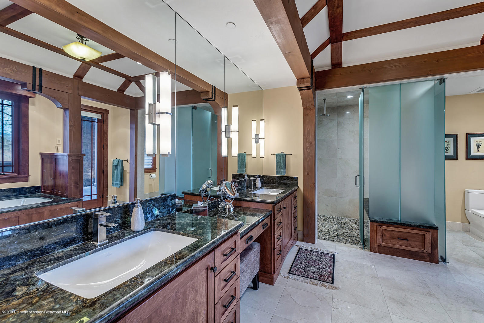 340 River's Bend Carbondale, CO 81623 - Photo 28 of 54 a spacious bathroom with a granite countertop sink a mirror and a shower