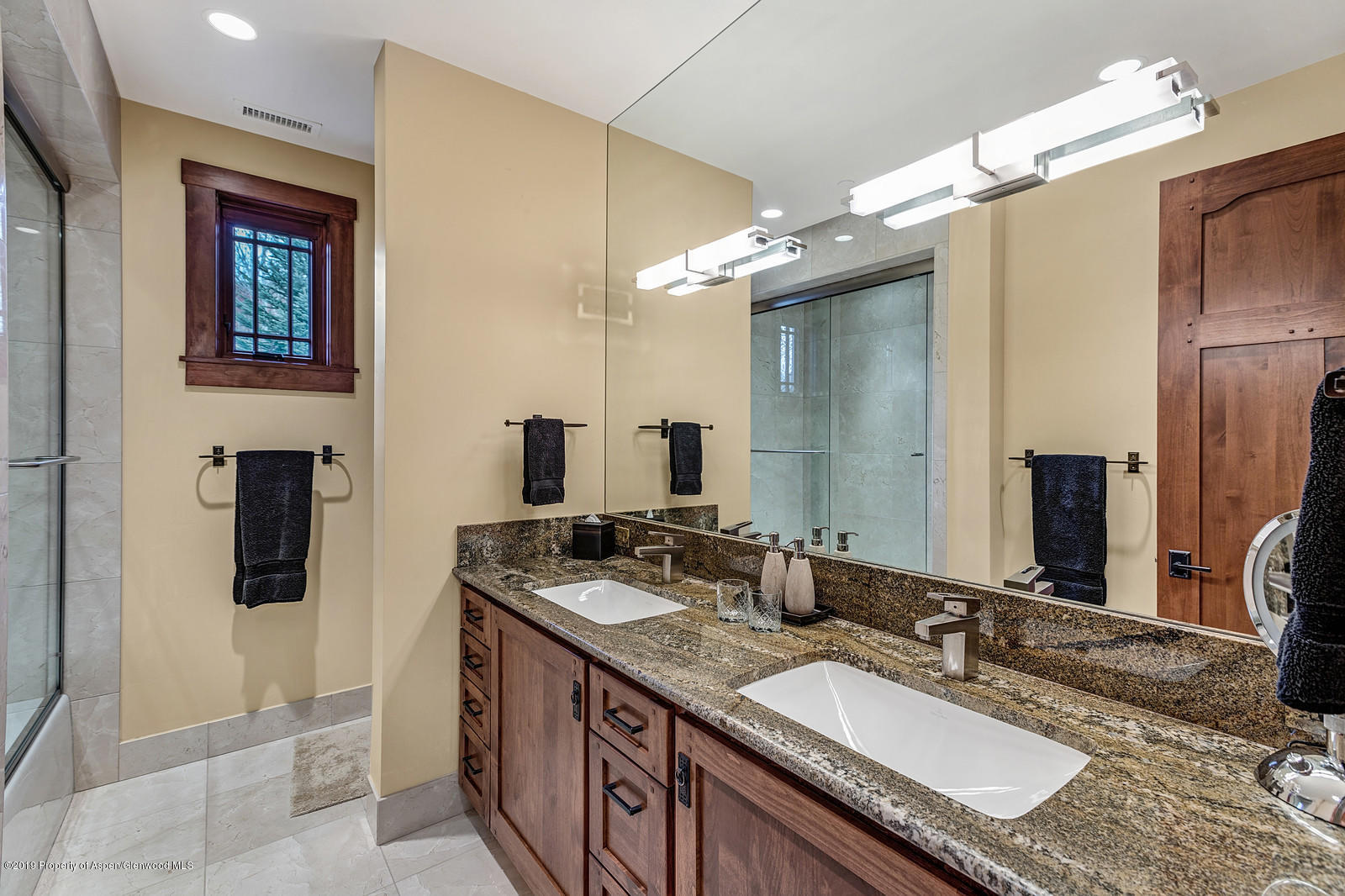 340 River's Bend Carbondale, CO 81623 - Photo 37 of 54 a bathroom with a granite countertop sink a mirror and a shower