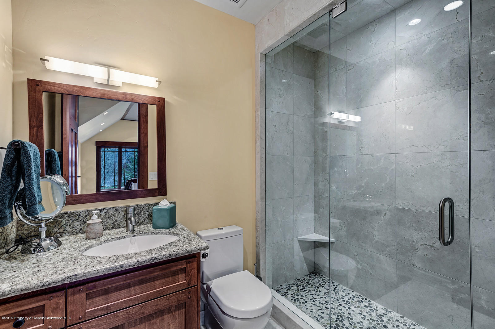 340 River's Bend Carbondale, CO 81623 - Photo 46 of 54 a bathroom with a granite countertop sink toilet a mirror and shower