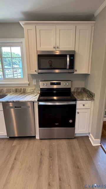 3817 Bridgeton Road Richmond, VA 23234 - Photo 6 of 23 a kitchen with stainless steel appliances granite countertop a stove a microwave and a white cabinets