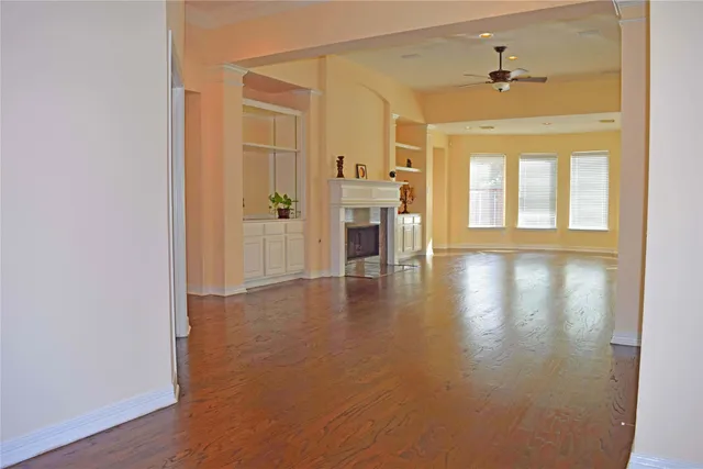 a view of a livingroom with wooden floor and a window