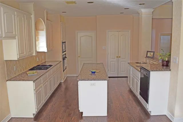 a kitchen with a stove a sink and a refrigerator
