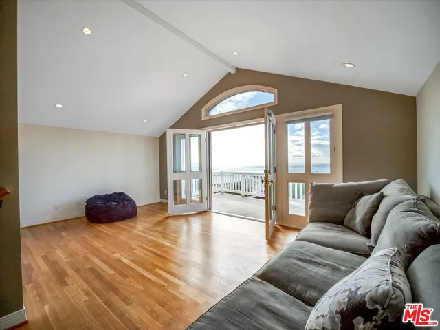 a living room with furniture and a floor to ceiling window