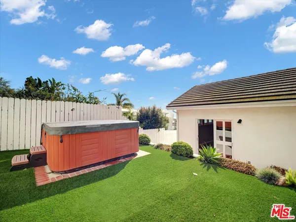 a view of a backyard with plants and a garden