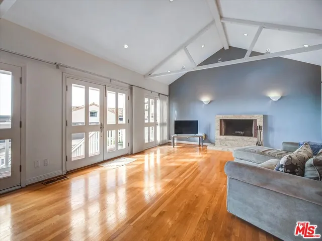a large room with pool table and windows