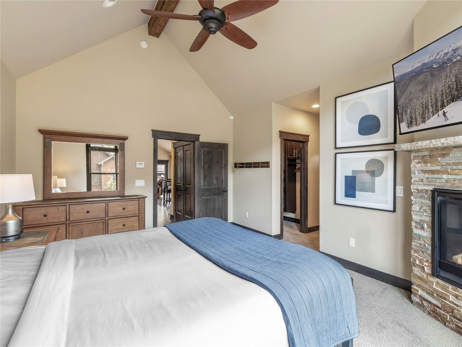 68 Independence Lane Keystone, CO 80435 - Photo 20 of 43 a bedroom with a large bed and a chandelier