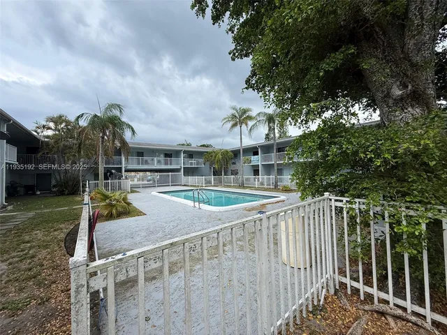 a view of a park with iron fence