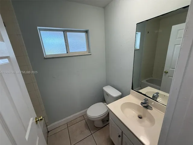 a bathroom with a sink toilet and a mirror
