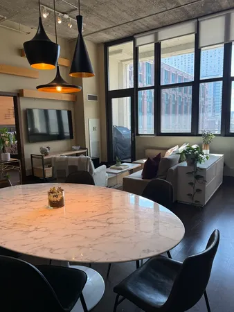 a kitchen with a table chairs and a wooden floor