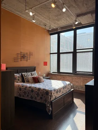 a bedroom with a bed and window