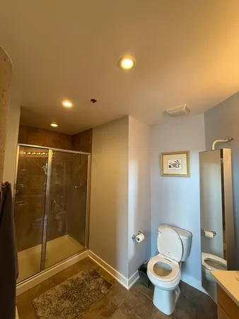 a bathroom with a shower toilet and sink