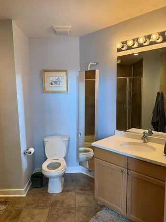 a bathroom with a toilet sink and mirror