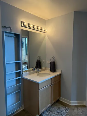 a room with a sink cabinets and appliances