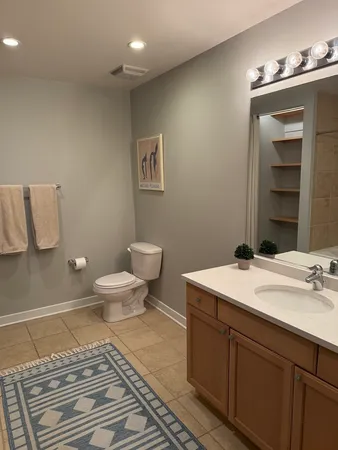 a bathroom with a toilet a sink and mirror