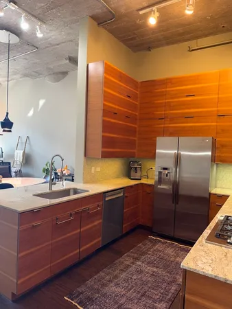 a kitchen with stainless steel appliances wooden cabinets and a sink