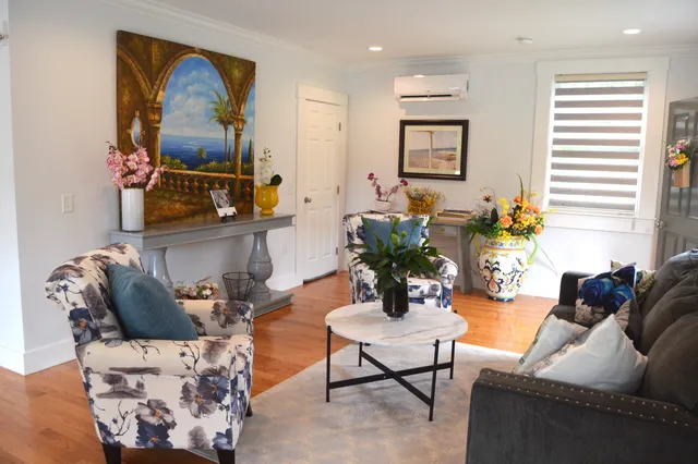 a living room with furniture and wooden floor