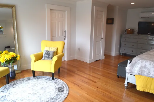 a workspace with wooden floor and furniture
