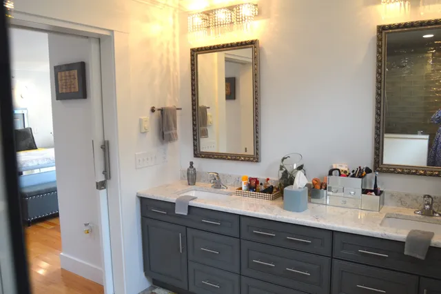 a bathroom with a sink double vanity and a mirror