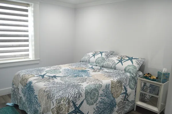 a bed sitting in a bedroom next to a window