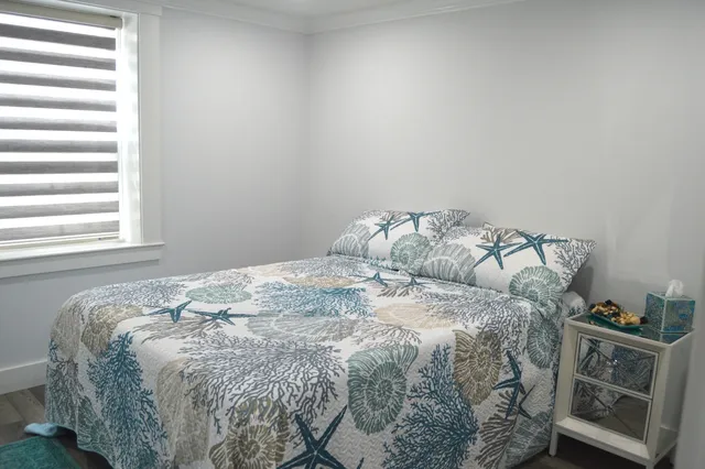 a bed sitting in a bedroom next to a window