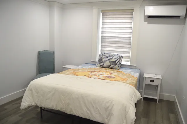 a bedroom with a bed and a window