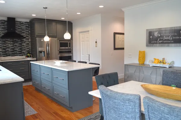 a kitchen with kitchen island cabinets and sink