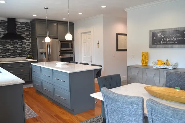 a kitchen with kitchen island cabinets and sink