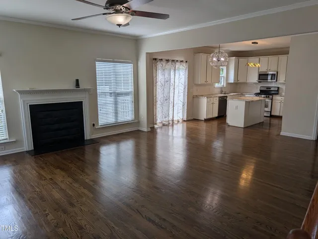 a view of a kitchen with a stove wooden floor and a kitchen